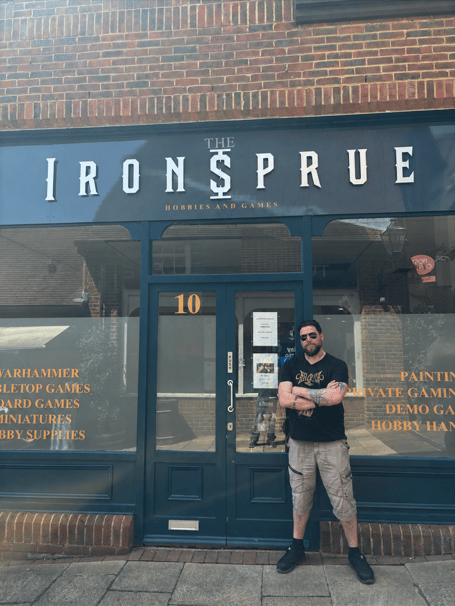 Owner Tim Hull-Daley standing outside The Iron Sprue shop front in Alton